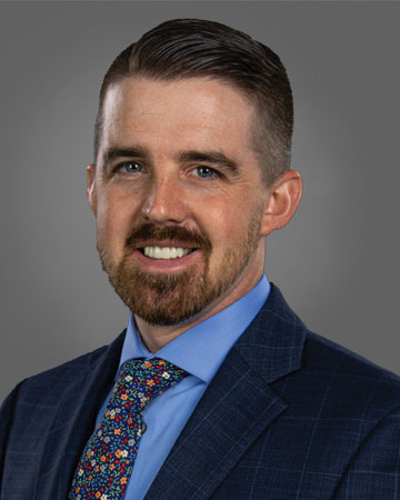 Ryan Bossart a man wearing a suit and tie