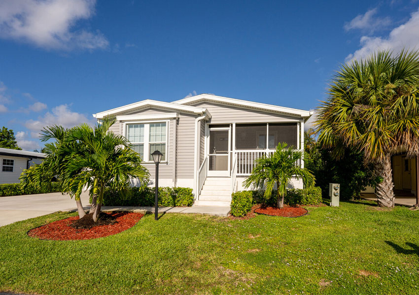 a white house with palm trees