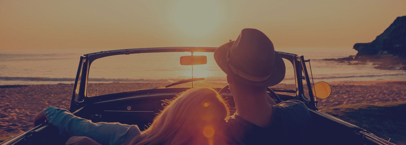 a person driving a car on a beach