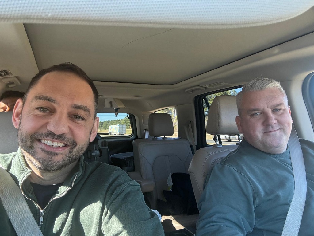 two men sitting in a car